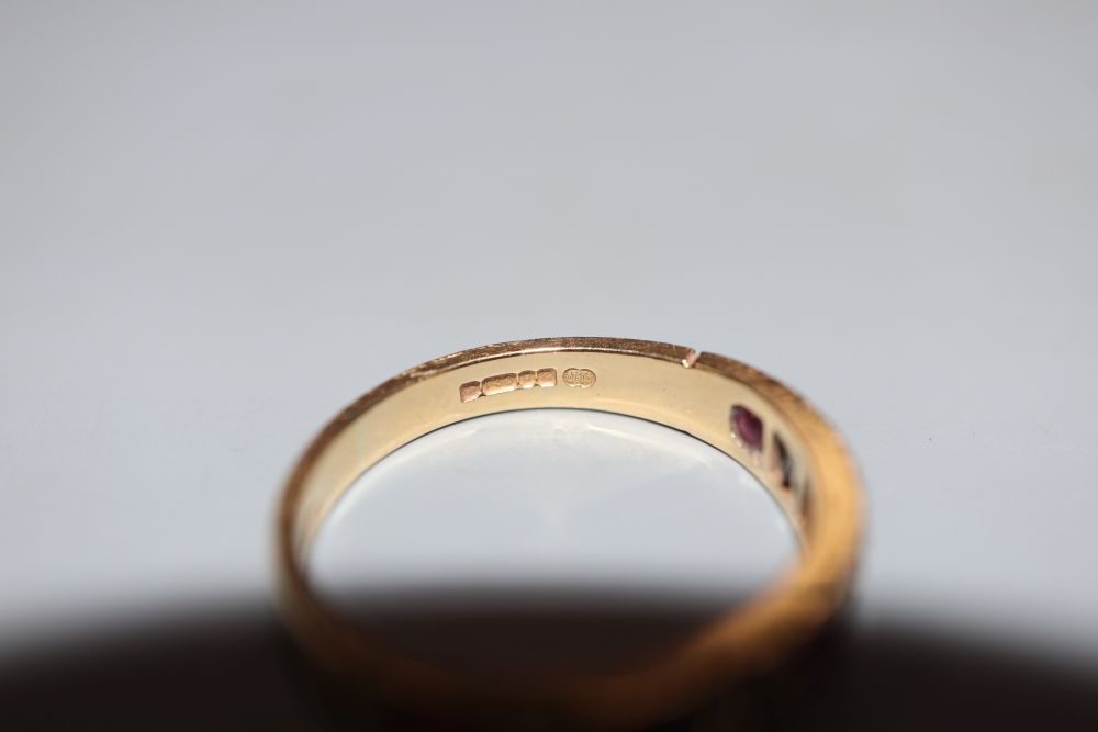 A modern 18ct gold, ruby and diamond set nine stone half hoop ring, size M, gross 3.2 grams.